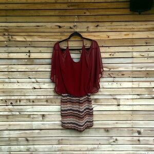 Dress. Red cut out shoulder, sheer sleeves with attached patterned skirt.